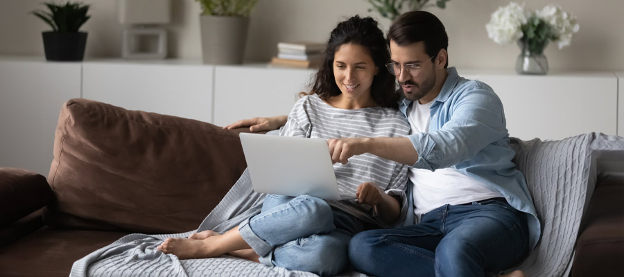 couple doing financial wellness checkup together on laptop